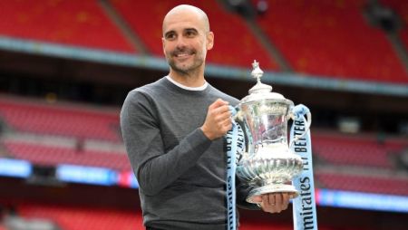 Pep Guardiola lifting his fourth League Cup title of the past four seasons.
